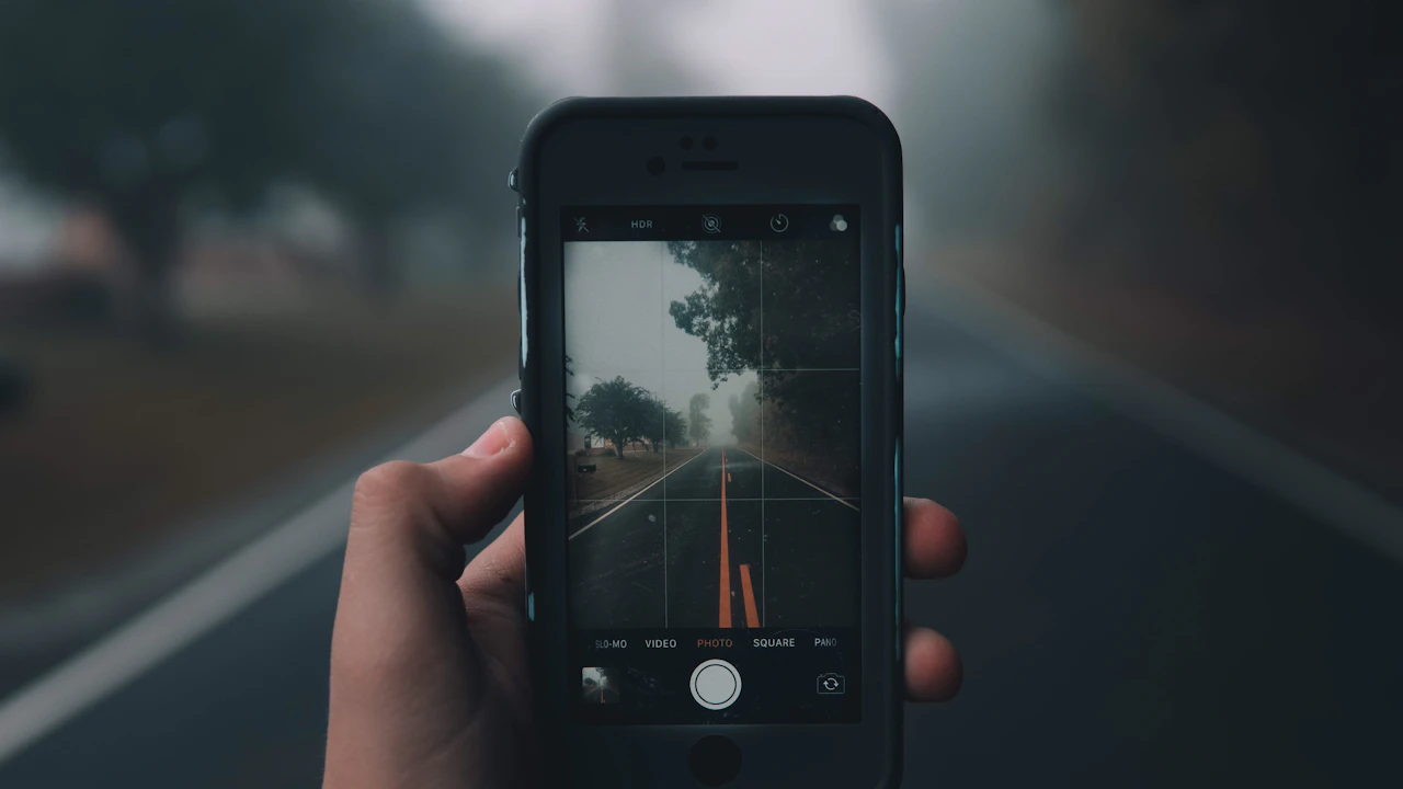 A smartphone camera frames a road for a social content recording