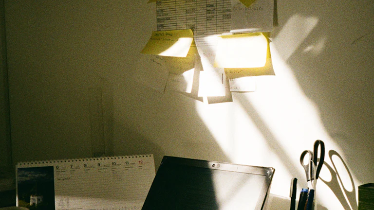 A campaign planning workspace with a laptop, calendar, and sticky notes