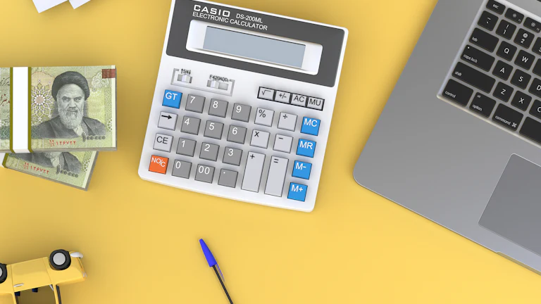 A calculator, laptop, and cash arranged for campaign budget planning